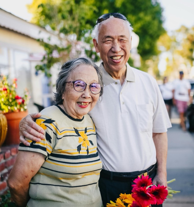 A senior couple smiling together outdoors